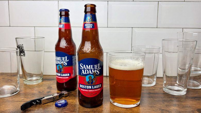 Bottles of Samuel Adams Boston lager with full and empty glasses