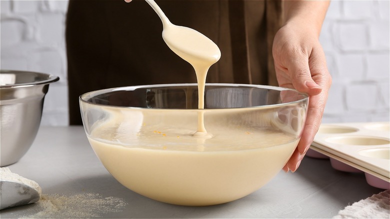 woman's hands stirring a bowl of batter