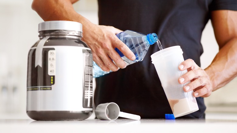 A man making a protein shake 