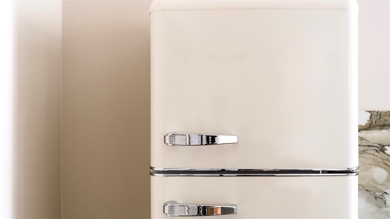 A retro-inspired refrigerator in a neutral-colored kitchen.