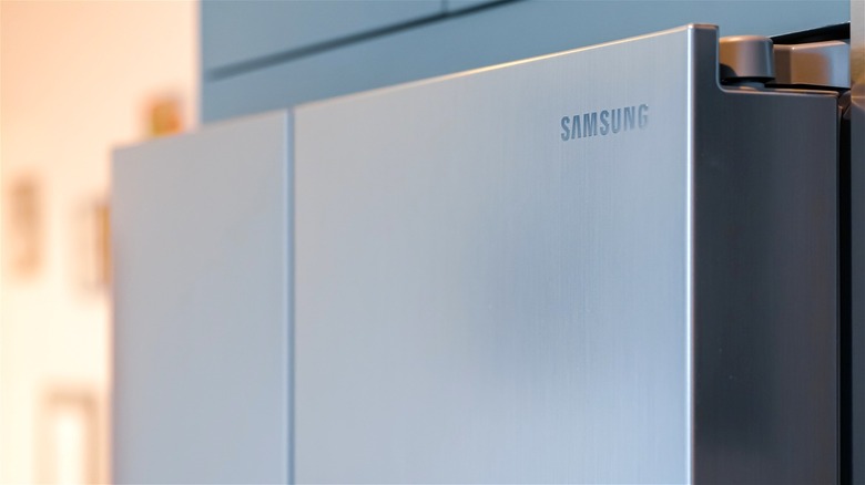 A close-up of a Samsung refrigerator, with the brand's logo prominently displayed.