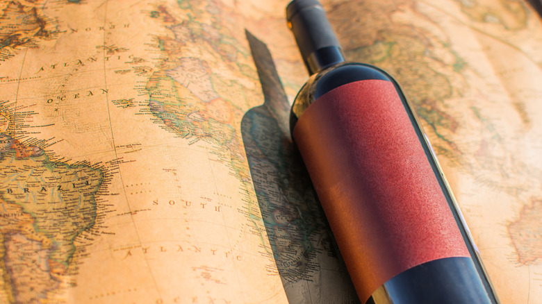 Bottle of wine and antique world map