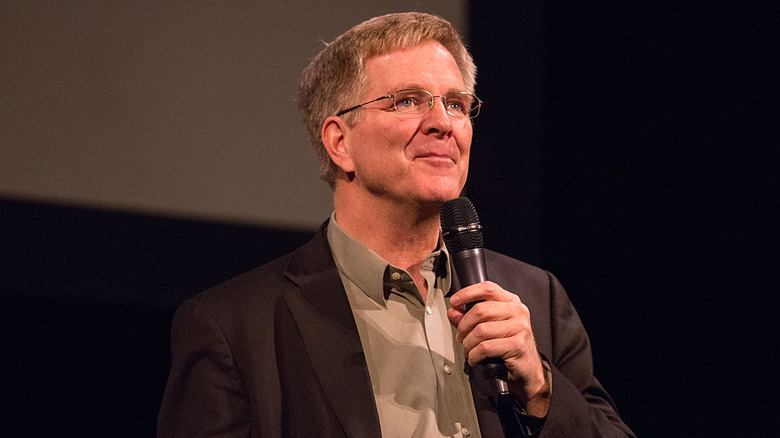 Rick Steves holding microphone