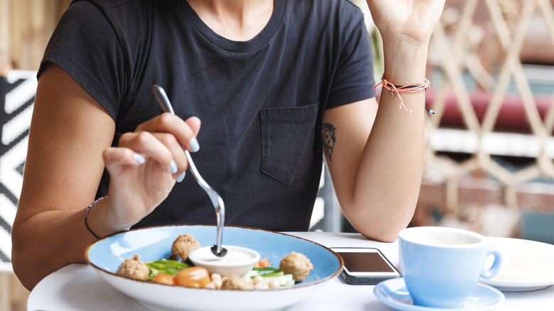 woman eating in restaurant