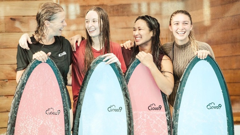 Four young women with surf boards 