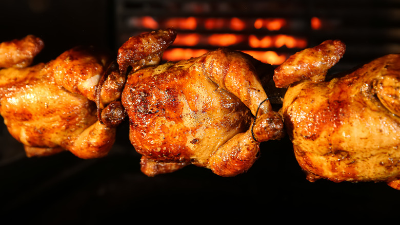 Rotisserie chickens being cooked