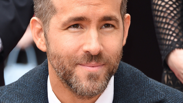 ryan reynolds slightly smiling