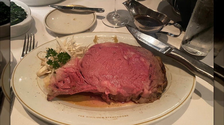 A slice of prime rib served with au jus