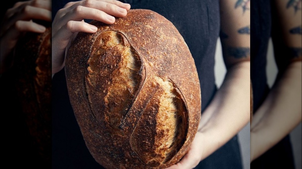 Baker displaying home-baked bread