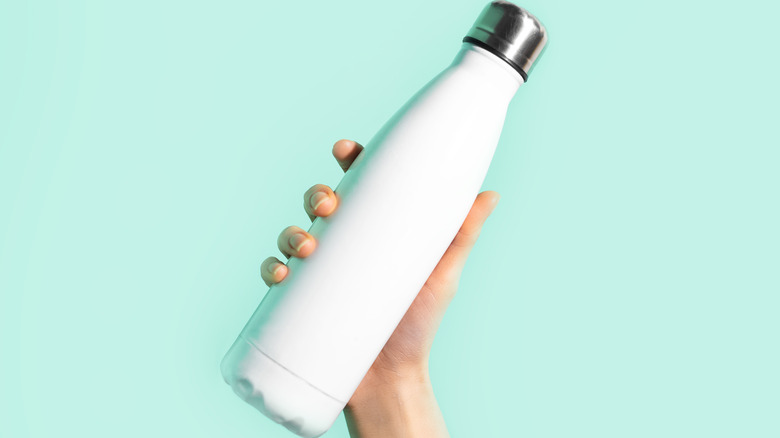 Hand holding water bottle
