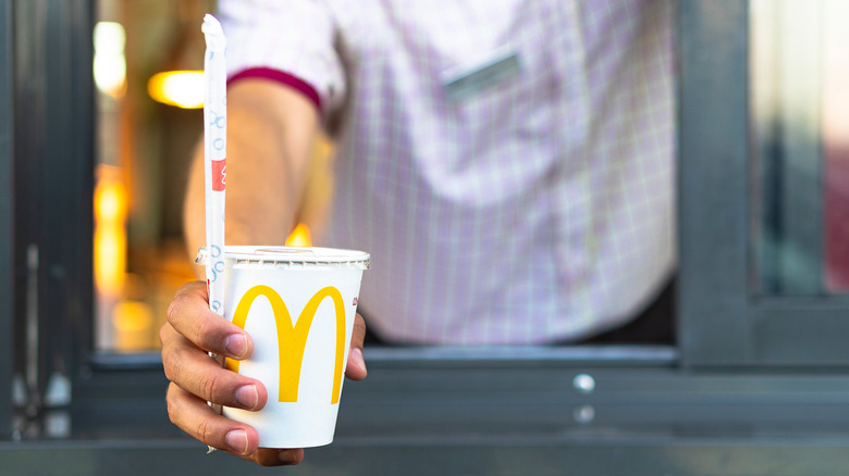 McDonald's employee hands out drink