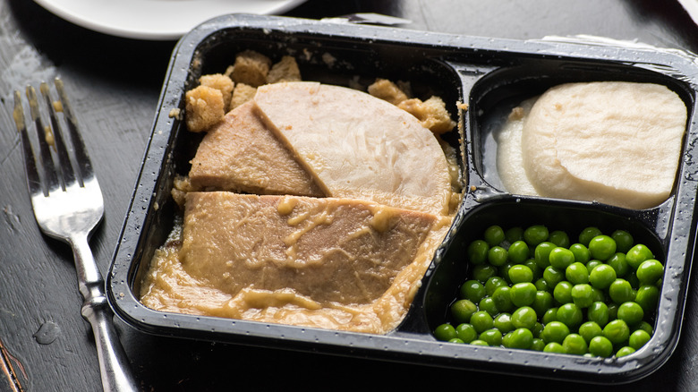 A TV dinner with turkey, mashed potatoes, and peas