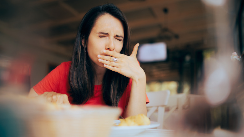 woman covering mouth with hand