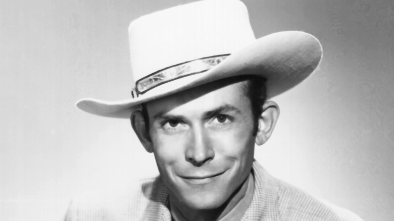 Hank Williams smiling, wearing a hat