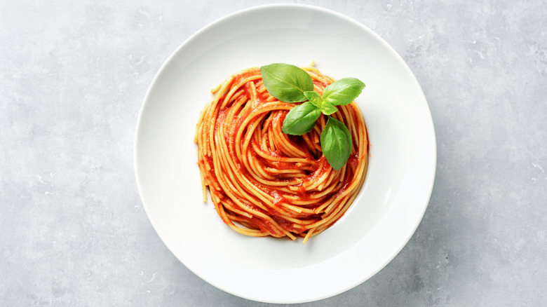spaghetti with tomato sauce on a white plate