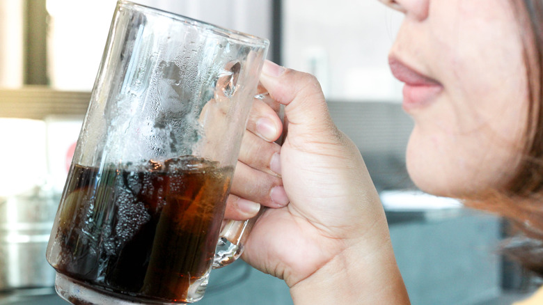 Middle aged woman drinking root beer