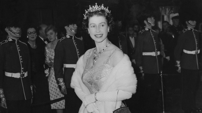 Queen Elizabeth II smiling with members of the Royal Guard