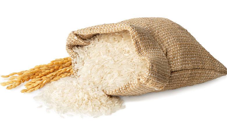 Rice spilling from burlap sack