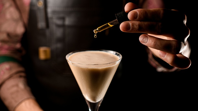 bartender mixing drink with dropper