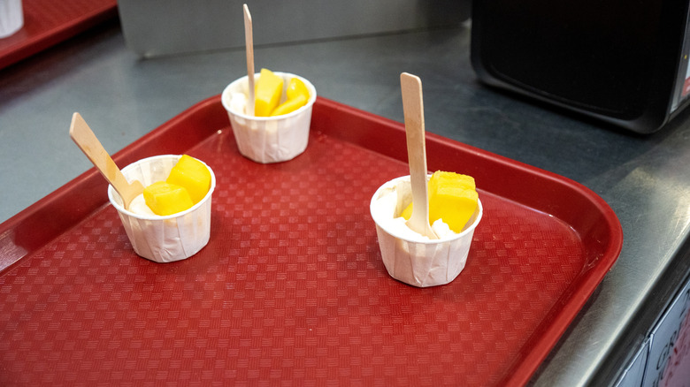 Fruit samples in cup on red tray
