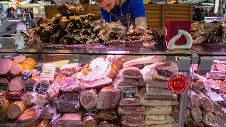 Deli meats behind a glass case 