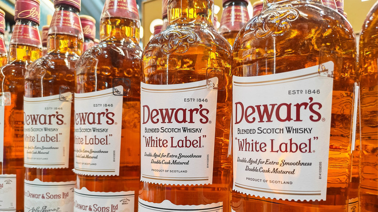 Multiple bottles of Dewar's white label whisky