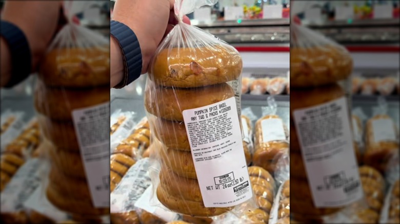 Person holding pumpkin spice bagels in Costco bakery