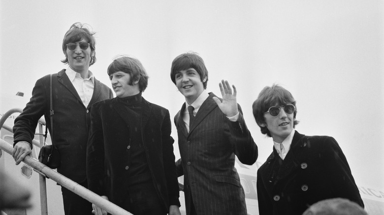 The Beatles boarding a plane on tour