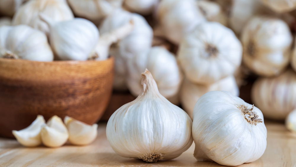 Garlic in a bowl on a cutting board