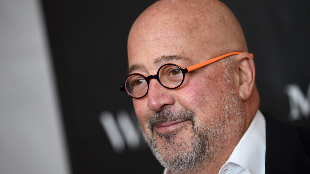 Andrew Zimmern in black glasses