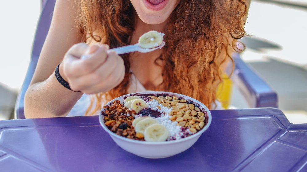 Woman eating acai bowl