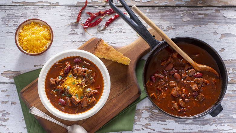 Pot and bowl of chili with cornbread