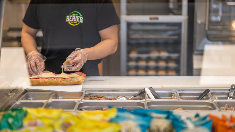 subway employee making sandwich