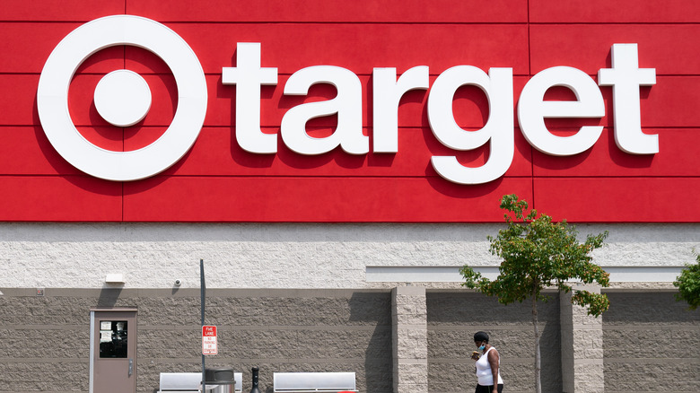 Woman walking outside building with red Target logo