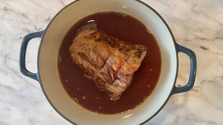 meat and liquid in a white pot