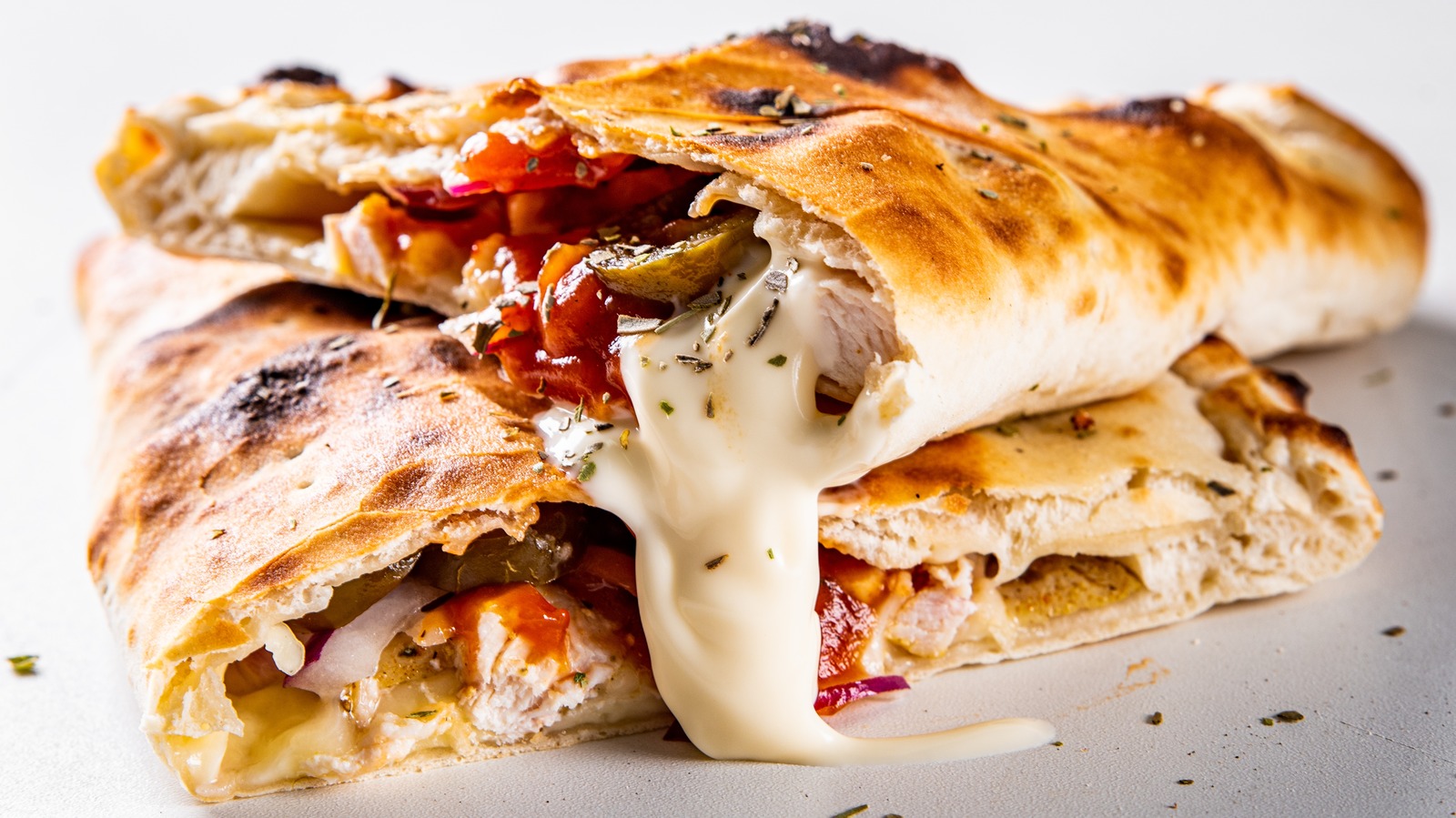 The Secret To Properly Adding Cheese To A Calzone