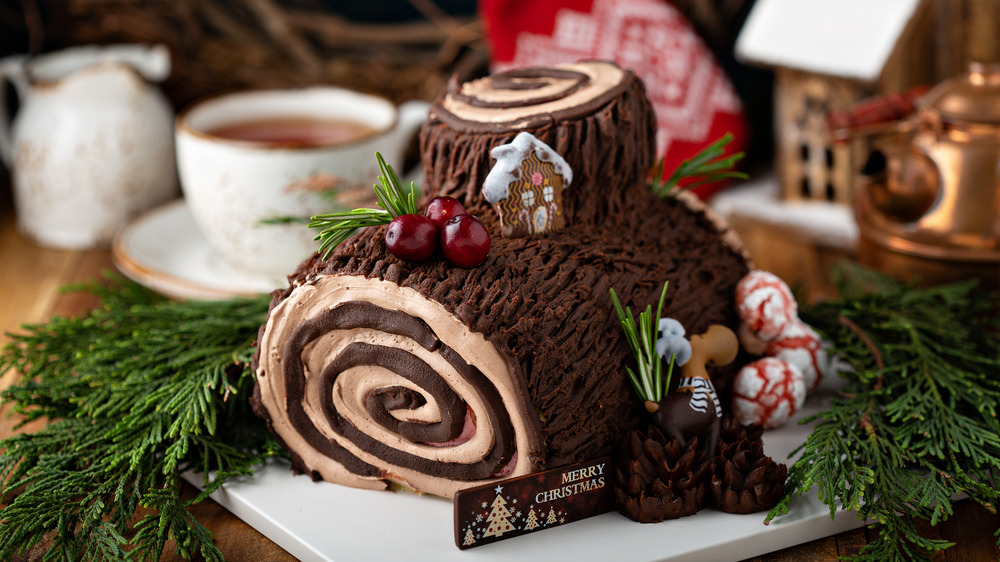 Yule log, with Christmassy garnishes and coffee cup 