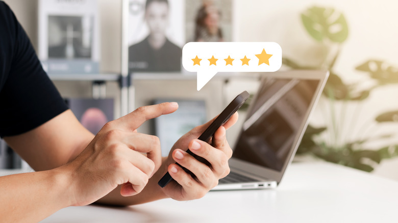 Graphic representation of person leaving a five-star review using their mobile device