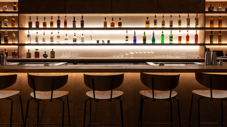 Empty bar with lit shelves.
