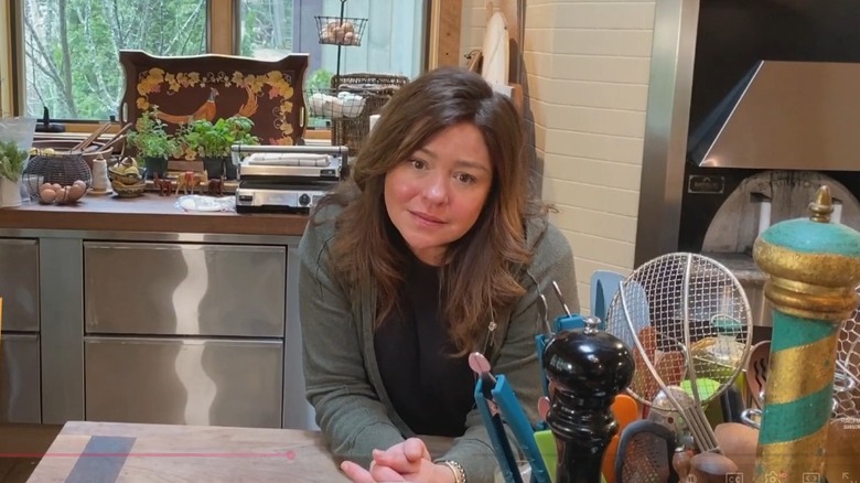 Rachael Ray leans on the kitchen counter in her home