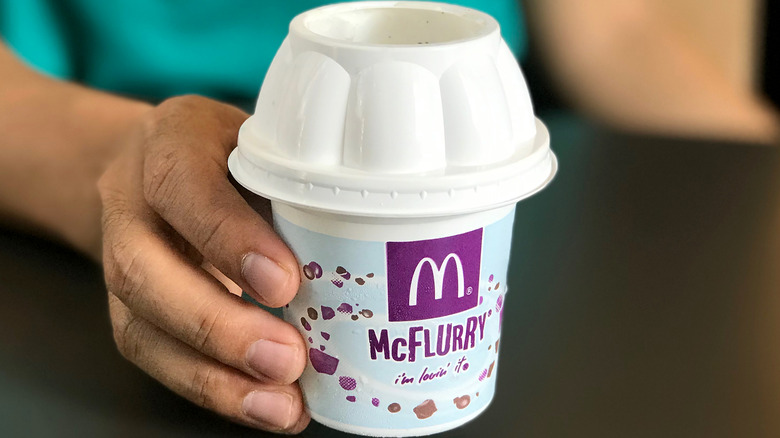 Hand holding McDonald's McFlurry ice cream