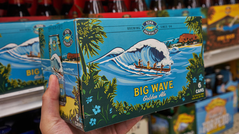 hand holding a box of Big Wave
