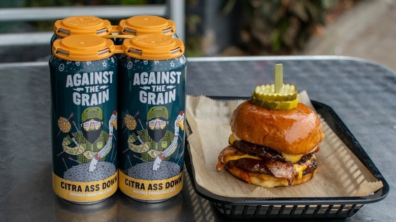 Citra Ass Down cans beside a burger