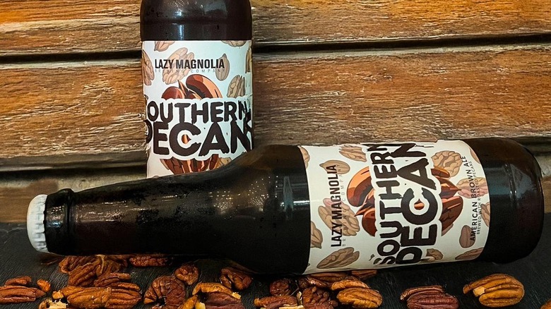 two Southern Pecan bottles amidst actual pecans