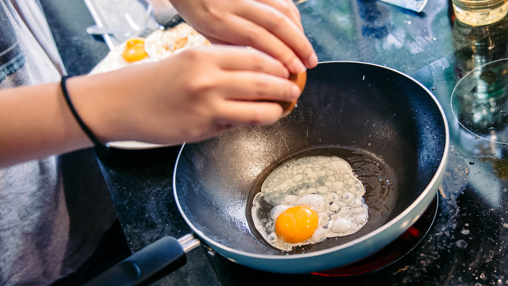 Cracking an egg into a frying pan