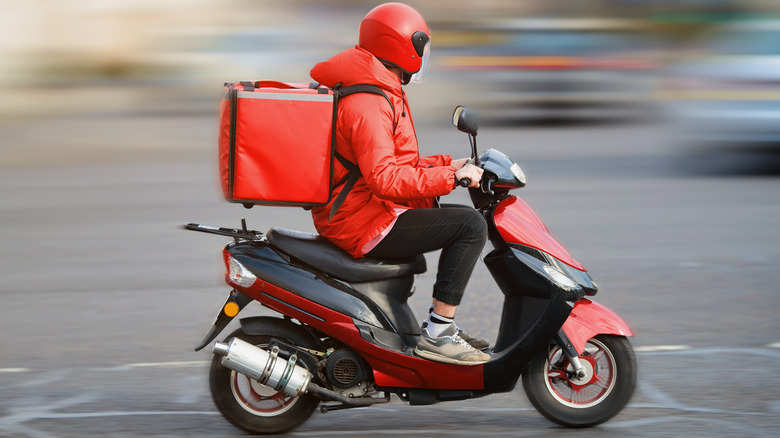 Food delivery person on motorbike