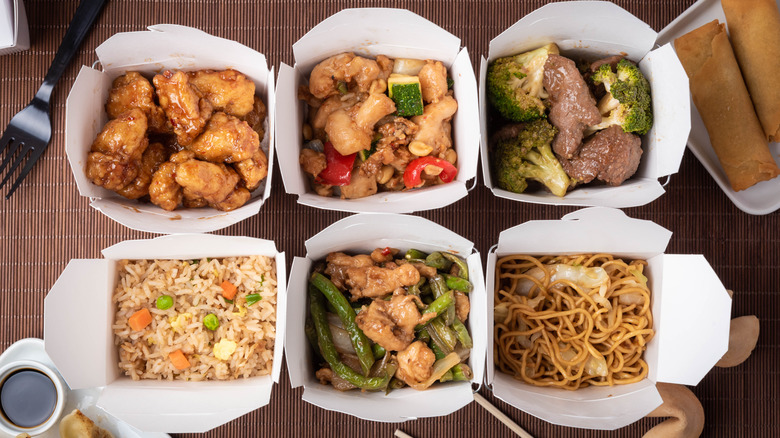 Chinese takeout boxes full of food 