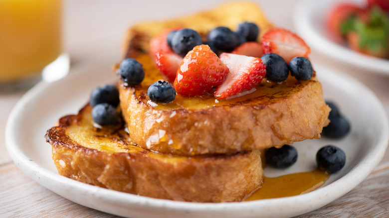 French toast topped with syrup and berries