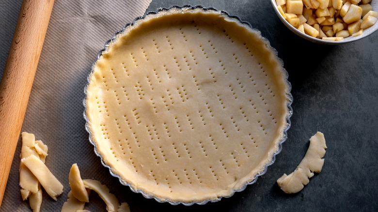 Unbaked pie crust with dough scraps