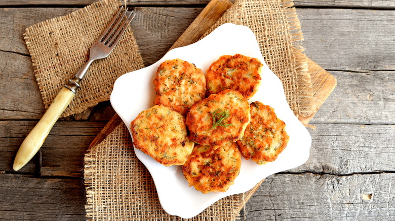 fried salmon patties on plate with fork